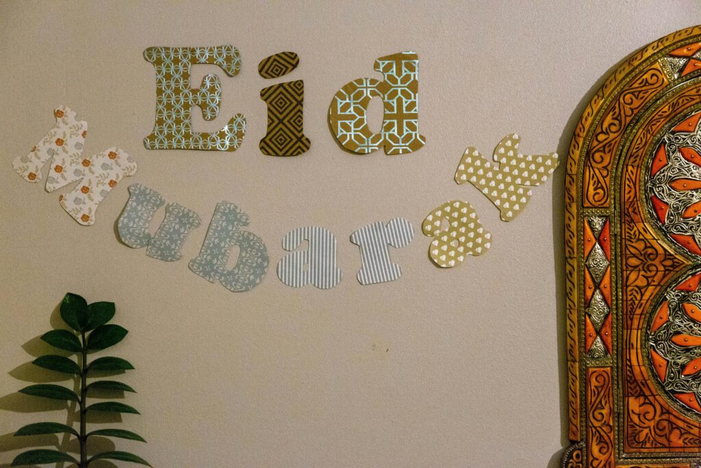 Close-up of decorative "Eid Mubarak" wall art with colorful patterns and intricate designs.