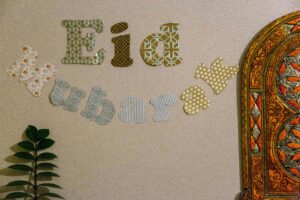 Close-up of decorative "Eid Mubarak" wall art with colorful patterns and intricate designs.